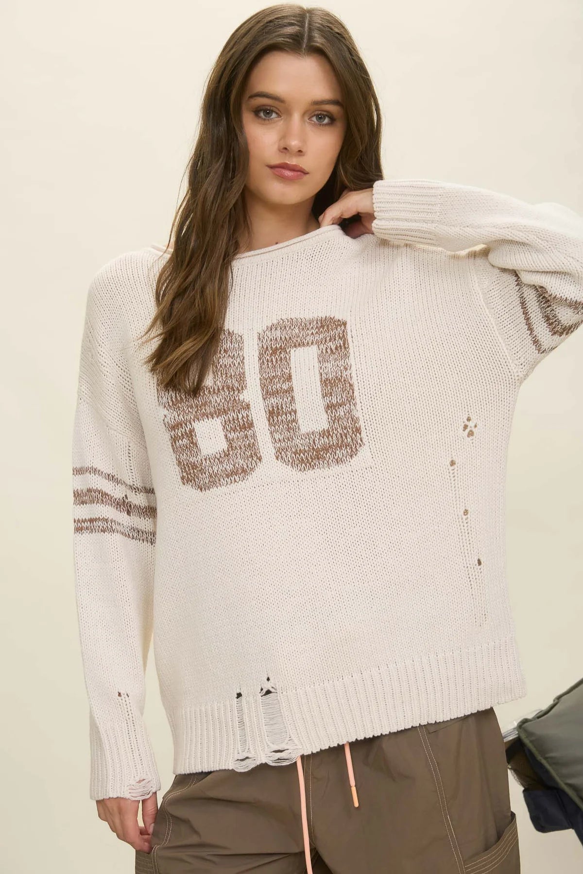 DISTRESSED LONG SLEEVE VARSITY KNIT SWEATER